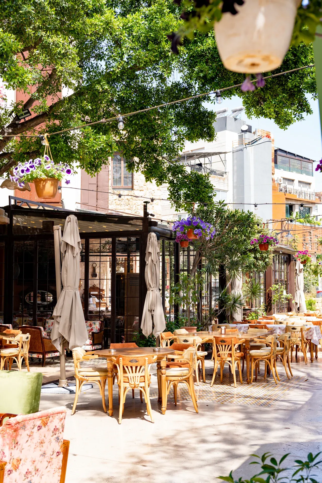 Tables set under the garden trees, Al Falamanki Antelias