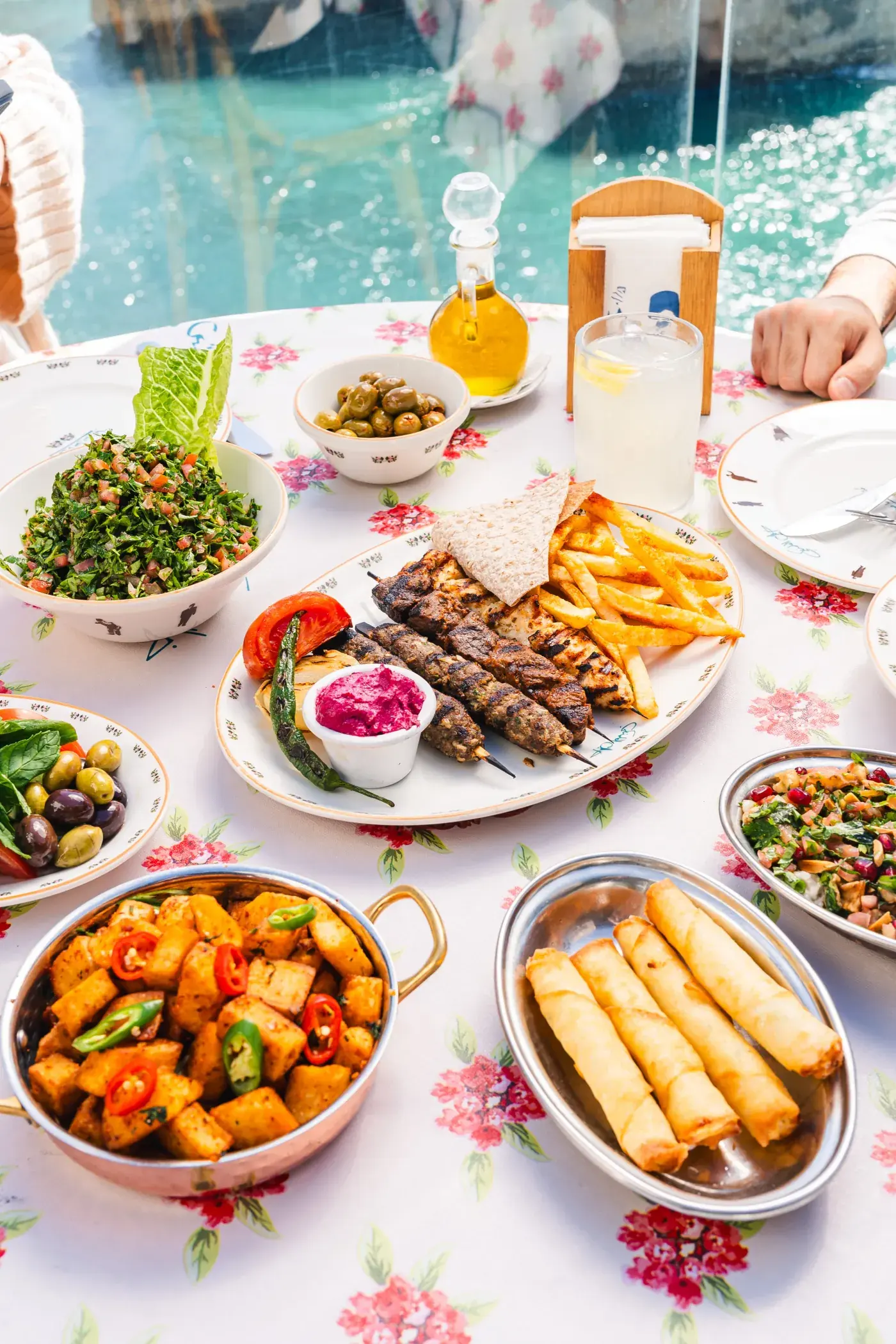 A table of mezze, hummus and fries by the window, Al Falamanki Raouche